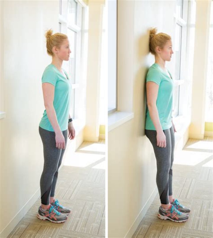 Does standing against a wall help posture?