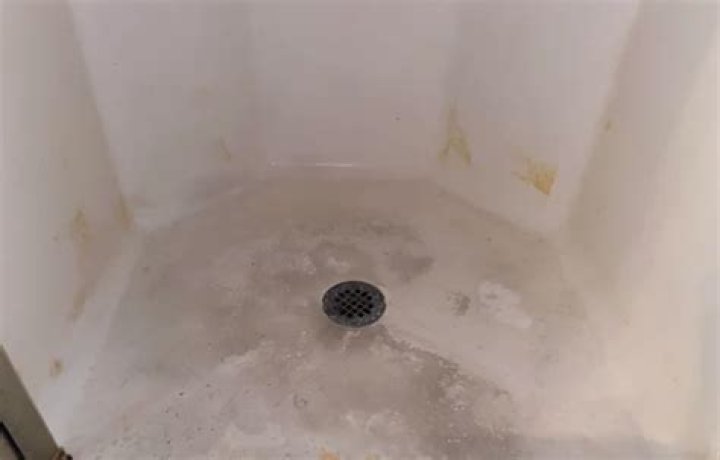 How do I get black marks off my shower floor?
